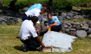 Still photographs showing a large piece of plane debris found on the beach in Saint-Andre, on the French Indian Ocean island of La Reunion on Wednesday (July 29). Investigations are underway to determine whether it came from Malaysia Airlines Flight MH370, which vanished last year in one of the biggest mysteries in aviation history. (Photo courtesy Reuters)