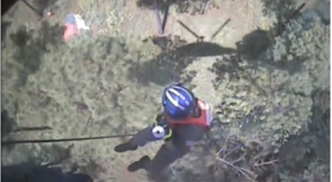 A rescue personnel sliding down an extended chord from helicopter towards fighter jet pilot. Major Aaron Johnson, the pilot who ejected safely, was rescued and taken for a health evaluation. (Courtesy Reuters/Photo grabbed from Reuters video)