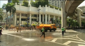 Street cleaners scrub and clean the blood-stained streets following the explosion that killed 20 people and left 125 seriously injured.  (Photo courtesy CCTV news)