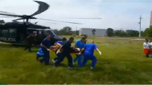 Sixteen police officers die and two are injured when their Black Hawk helicopter crashes in Colombia.  A rescued injured police officer is seen here being carried to a waiting ambulance.  (Photo grabbed from Reuters video/Courtesy Reuters)