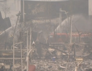 Firefighters dousing water at blast site in Tianjin, China. (Photo grabbed from CCTV video/Courtesy CCTV)