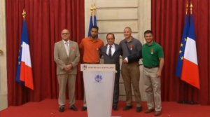 France honors three U.S. citizens and a Briton who helped disarm a machine gun-toting suspected Islamist militant on a train last week. Spencer Stone, 23, student Anthony Sadler, also 23, National Guardsman Alek Skarlatos, 22, and Chris Norman, a 62-year-old British consultant who lives in France, were awarded France's highest honour, the Legion d'honneur, by French President Francois Hollande at a ceremony held at the Elysee palace. (Courtesy Reuters/Photo grabbed from Reuters video)