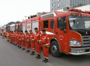 Officials, firefighters, policemen and locals mourn the victims of the massive Tianjin warehouse blasts at the accident site in north China's port city of Tianjin on Tuesday.  (Courtesy China Central Television news/Photo grabbed from CCTV video)