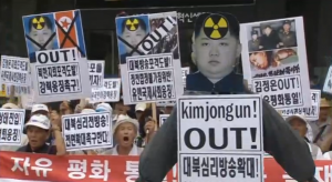 South Korean protesters rally against North Korea in Seoul after the North's leader Kim Jong Un ordered troops on war footing following an exchange of fire with South. (Courtesy Reuters/photo grabbed from Reuters video)
