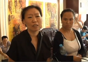 Wang Liying, mother of a 19-year-old firefighter reported missing after going to the site of the chemical blasts in Tianjin. China.  (Photo grabbed from CCTV footage/Courtesy China Central Television)