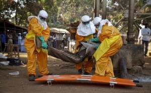A French Red Cross team picks up a suspected Ebola case from the centre of Forecariah January 30, 2015, REUTERS/Misha Hussain/Files