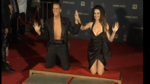 Katy Perry and designer Jeremy Scott have hand prints immortalized in cement in front Hollywood's Chinese Theater. (Photo captured from Reuters video)