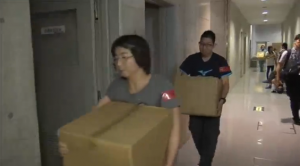 Volunteers carry boxes of relief goods into evacuation centers in Japan which had experienced the worst flooding in decades. (Photo grabbed from Reuters video)
