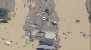 Even cars were washed away by raging flood waters in Japan after more rivers burst their banks. The floods in Japan have killed at least three people. (Photo grabbed from Reuters video)