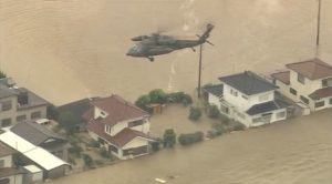 A rescue helicopter hovers above flooded homes in Japan. (Courtesy TV Tokyo/Photo grabbed from video provided by Reuters)