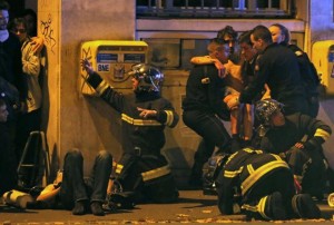 French fire brigade members aid an injured individual near the Bataclan concert hall following fatal shootings in Paris, November 13, 2015.  REUTERS/Christian Hartmann