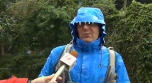Icicles form on the clothes of this man being interviewed by a news crew.  (Photo grabbed from Reuters video/Courtesy Reuters)