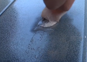 Because of China's icy weather, this wet pig skin sticks to a door in China and turns icy in a few seconds. (Photo grabbed from CCTV video)