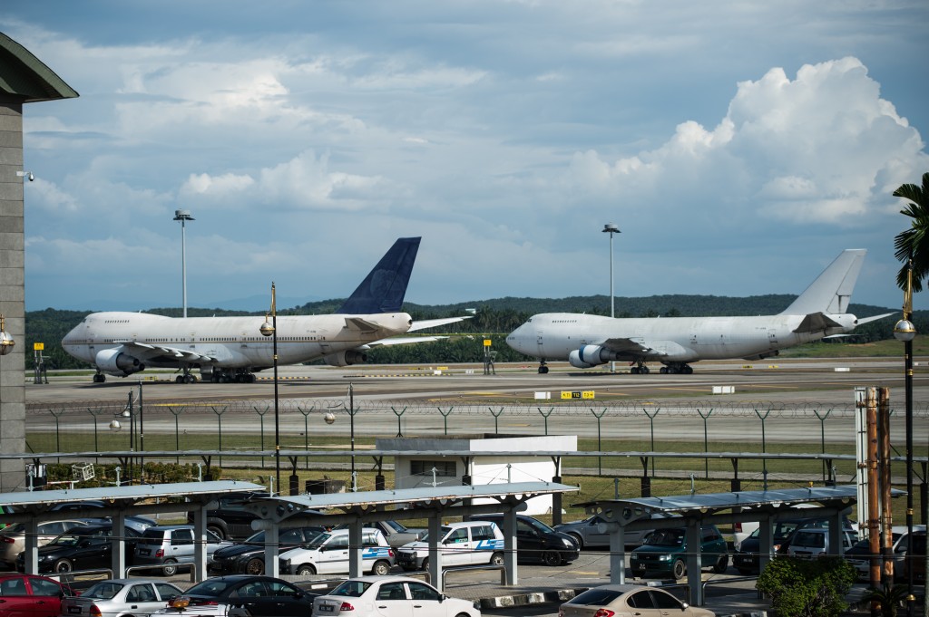 Boeing 747-200F planes with the registration numbers TF-ARM (L) and TF-ARN (R) are seen parked on the tarmac at Kuala Lumpur International Airport (KLIA) in Sepang on December 8, 2015. Still puzzled by the mystery of missing flight MH370, Malaysian airport authorities now have the opposite problem: three Boeing 747 planes left unclaimed at the country's main airport.   AFP PHOTO / MOHD RASFAN / AFP / MOHD RASFAN