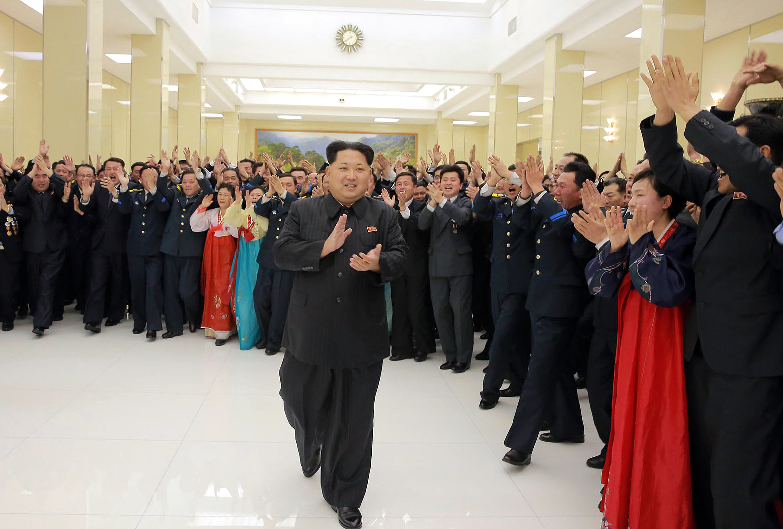 This photo taken on February 13, 2016 and released by North Korea's official Korean Central News Agency (KCNA) on February 15, 2016 shows North Korean leader Kim Jong-Un (C) being welcomed by people during a party for scientists who contributed to the launch of the earth observation satellite Kwangmyong in Pyongyang.  It was reported on February 15 that North Korean leader Kim Jong-Un has promised to put more satellites in space, even as the international community prepares to punish his regime over a long-range rocket launch just last week.        REPUBLIC OF KOREA OUT ----  AFP PHOTO / KCNA via KNS THIS PICTURE WAS MADE AVAILABLE BY A THIRD PARTY. AFP CAN NOT INDEPENDENTLY VERIFY THE AUTHENTICITY, LOCATION, DATE AND CONTENT OF THIS IMAGE. THIS PHOTO IS DISTRIBUTED EXACTLY AS RECEIVED BY AFP.  ---EDITORS NOTE--- RESTRICTED TO EDITORIAL USE - MANDATORY CREDIT "AFP PHOTO/KCNA VIA KNS" - NO MARKETING NO ADVERTISING CAMPAIGNS - DISTRIBUTED AS A SERVICE TO CLIENTS / AFP / KCNA / KNS