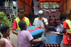 A photo taken on 25 February, 2016, and received on February 26 shows Red Cross handing out blankets in cyclone devastated Fiji.  Humanitarian aid was finally reaching isolated communities in Fiji devastated by super-cyclone Winston, with the government estimating the damage bill will top hundreds of millions of dollars.  AFP PHOTO / FIJI RED CROSS SOCIETY / NAKITA BINGHAM ----EDITORS NOTE ----RESTRICTED TO EDITORIAL USE MANDATORY CREDIT " AFP PHOTO / FIJI RED CROSS SOCIETY / NAKITA BINGHAM" NO MARKETING NO ADVERTISING CAMPAIGNS - DISTRIBUTED AS A SERVICE TO CLIENTS / AFP / FIJI RED CROSS SOCIETY / NAKITA BINGHAM