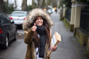 Ready to distribute copies of the Pasugo (God's Message) magazine in cold weather, an Iglesia Ni Cristo member -- all geared up for the cold -- makes a "thumbs up" sign as she carries envelopes containing Pasugo magazines in Bonn, Germany. (Eagle News Service)