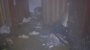 Slippers and various belongings are scattered in the flooded floor inside a massage parlor where the fire started at Capitol Hotel in Iraq's Kurdistan.  (Photo grabbed from Reuters video/Courtesy Reuters)