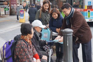 Iglesia Ni Cristo members in Japan hand a copy of Pasugo (God's Message) magazine to an elderly Japanese couple.  (Eagle News Service)