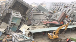 Rescuers rush to free people trapped inside an apartment building following a strong earthquake in Taiwan. (Courtesy Reuters/Photo grabbed from Reuters video)