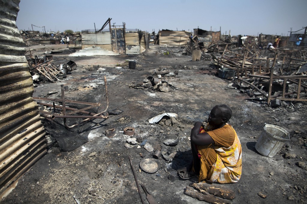 This file photo taken on February 26, 2016 shows Akki Adduok, a displaced woman residing in the Protection of Civilians (PoC) site in Malakal, South Sudan, sitting in the spot where her shelter used to be. (AFP)