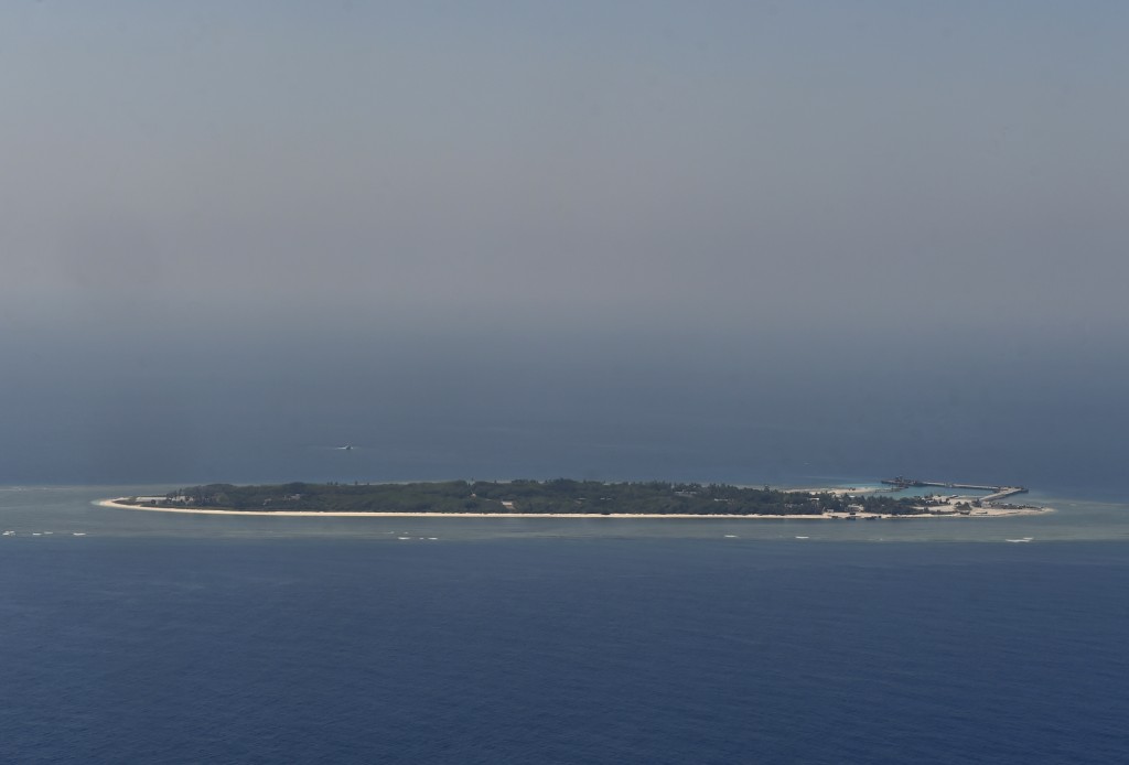 This aerial image taken from a C-130 transport plane shows a general view of Taiping island during a visit by journalists to the island, in the Spratlys chain in the South China Sea on March 23, 2016. Taiwan on March 23 gave its first ever international press tour of a disputed island in the South China Sea to boost its claim, less than two months after a visit by its leader sparked protests from rival claimants. / AFP / SAM YEH