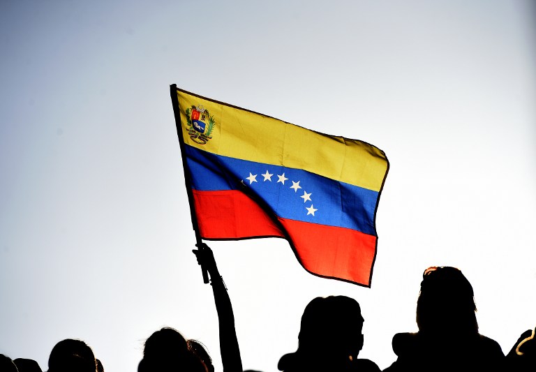 Supporters of Venezuelan President Nicolas Maduro attend a rally at Miraflores presidential palace in Caracas on March 8, 2016. Venezuela's opposition called Tuesday for the "largest movement that has ever existed" to oust President Nicolas Maduro, vowing to pursue all means to force him from power, including a referendum and protests. AFP PHOTO/JUAN BARRETO / AFP / JUAN BARRETO