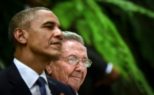 Sitting next to Cuban President Raul Castro (R), US President Barack Obama (L) smiles during the state dinner at the Revolution Palace in Havana on March 21, 2016. Obama and Castro vowed Monday in Havana to set aside their differences in pursuit of what the US president called a "new day" for the long bitterly divided neighbors. AFP PHOTO/Adalberto Roque 