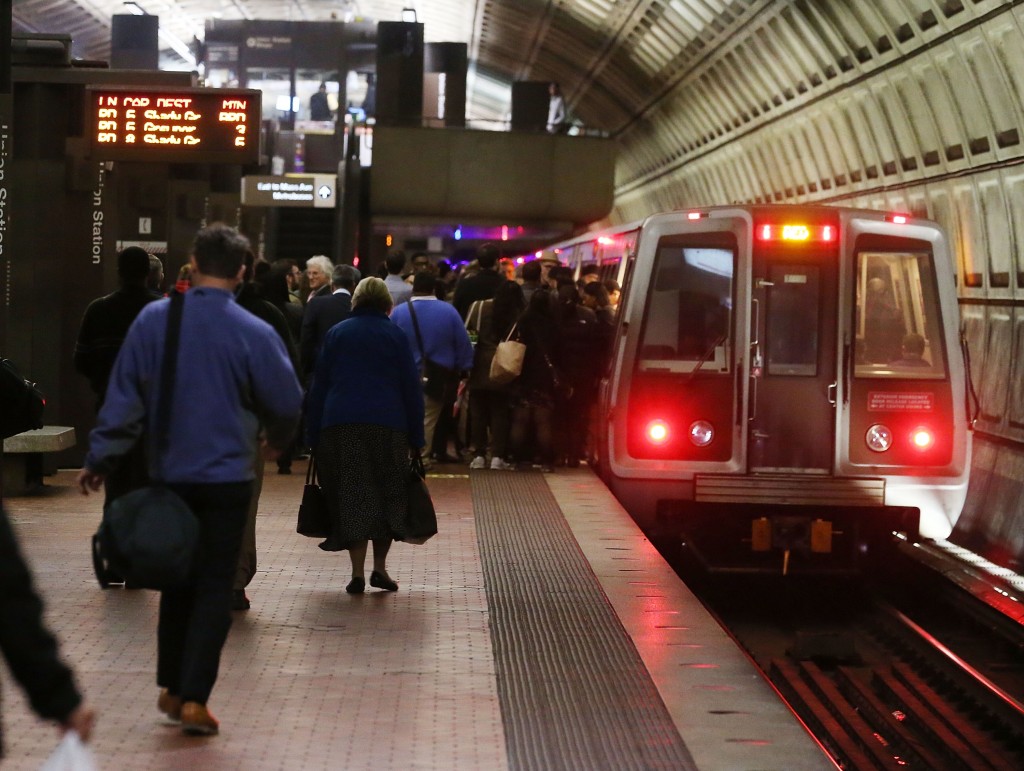 WASHINGTON, DC - MARCH 15: Commuters board a Metrorail train at Union Station, March 15, 2016 in Washington, DC. Metrorail announced today that they will shut down service entirely on Wednesday for emergency inspections of the system's third-rail power cables after a tunnel fire earlier in the week.   Mark Wilson/Getty Images/AFP