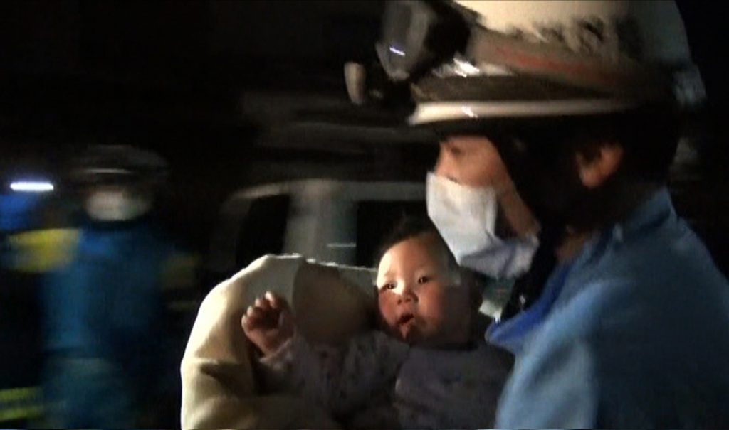 This handout image taken from video footage released by the Kumamoto Prefectural Police on April 15, 2016 shows a rescue worker carrying an eight-month-old baby girl after she was pulled from the rubble following an earthquake in Mashiki, Kumamoto Prefecture. Rescuers were scrambling to find survivors on April 15 after a powerful earthquake in southern Japan that left at least nine people dead and hundreds injured, sparking fires and buckling roads. / AFP PHOTO / Kumamoto Prefectural Police / STR / Japan OUT / RESTRICTED TO EDITORIAL USE - MANDATORY CREDIT "AFP PHOTO / Kumamoto Prefectural Police " - NO MARKETING NO ADVERTISING CAMPAIGNS - DISTRIBUTED AS A SERVICE TO CLIENTS - NO ARCHIVES