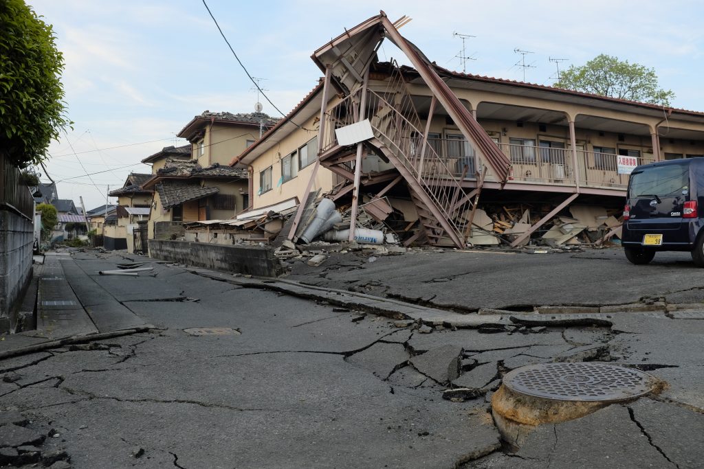 Collapsed houses are seen in Mashiki, Kumamoto prefecture on April 16, 2016. A powerful earthquake hit southern Japan early April 16, authorities said, sending panicked residents out of their homes in a region where nerves were already frayed by a swarm of strong shaking. / AFP PHOTO / KAZUHIRO NOGI