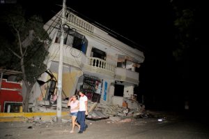 Residents walk on a street amid destroyed buildings following an earthquake, April 16, 2016 in Guayaquil, Ecuador. At least 28 people were killed by a strong 7.8-magnitude earthquake that struck northwestern Ecuador, the country's Vice President Jorge Glas said. A tate of emergency had been declared nationwide. / AFP PHOTO / ARIEL OCHOA