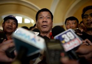 (FILES) This file photo taken on March 2, 2016, shows Davao City Mayor and Presidential Candidate Rodrigo Duterte speaking to reporters during his campaign sortie in Lingayen, Pangasinan, north of Manila. Leading Philippine presidential candidate Rodrigo Duterte, whose campaign promises a ruthless war on crime, was condemned on April 17, 2016 after a video surfaced of him apparently joking about a murdered Australian rape victim. / AFP PHOTO / NOEL CELIS