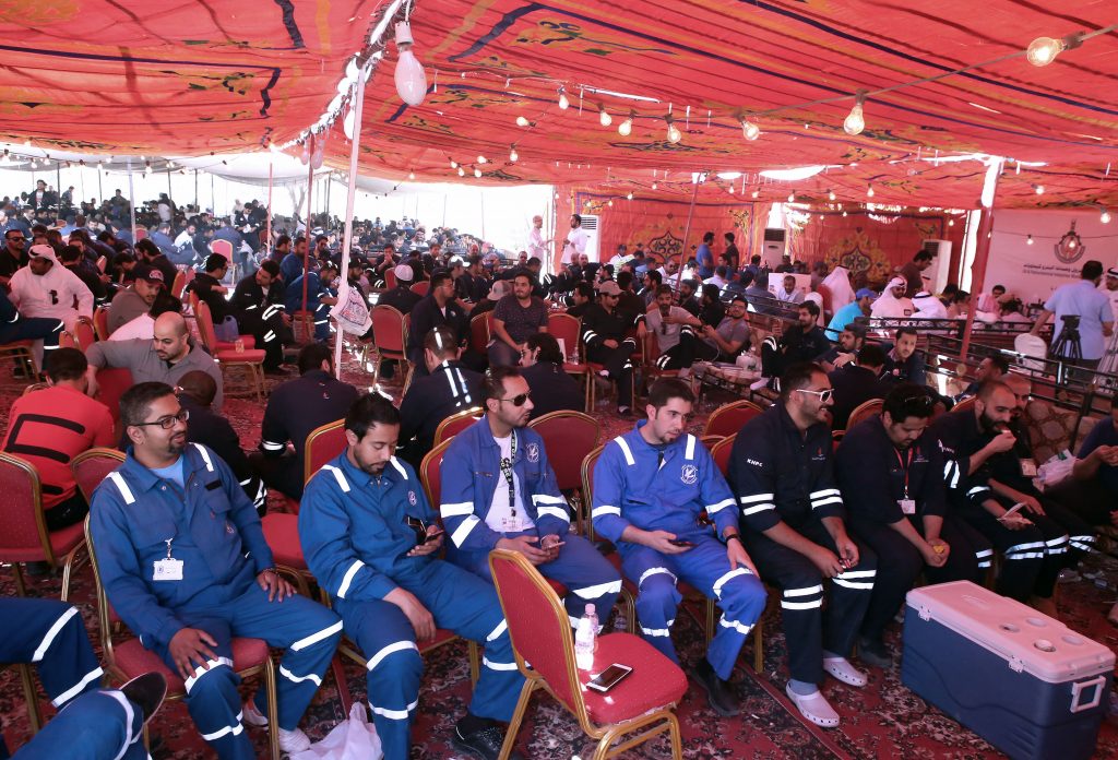 Kuwaiti oil workers sit at the union's headquarters in Al-Ahmadi, 35 kilometres south of Kuwait City, on April 19, 2016, as they participate in the third day of strikes to protest alleged pay cuts and plans to privatise parts of the oil sector. The strike by oil workers has slashed Kuwait's output, but the state oil firm, Kuwait Petroleum Corp, said it had managed to restore some affected production. / AFP PHOTO / YASSER AL-ZAYYAT