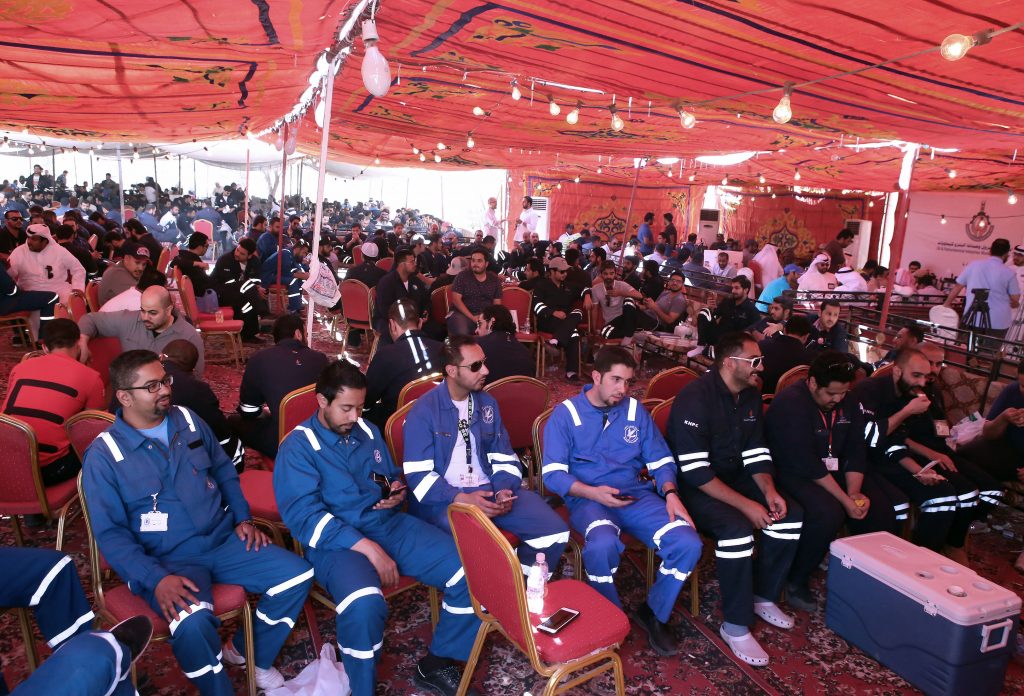 Kuwaiti oil workers sit at the union's headquarters in Al-Ahmadi, 35 kilometres south of Kuwait City, on April 19, 2016, as they participate in the third day of strikes to protest alleged pay cuts and plans to privatise parts of the oil sector. The strike by oil workers has slashed Kuwait's output, but the state oil firm, Kuwait Petroleum Corp, said it had managed to restore some affected production.  / AFP PHOTO / YASSER AL-ZAYYAT