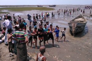 A handout photo taken on April 19, 2016 and released to AFP from anonymous Rohingya Muslim minority residents shows people carrying a dead body after a boat capsized off the coast in Sittwe. Witnesses to a boat capsize that left some 20 people dead, including children, say the victims were from the persecuted Rohingya Muslim minority and blamed the tragedy on restrictions that forced them to journey by sea. / AFP PHOTO / STR