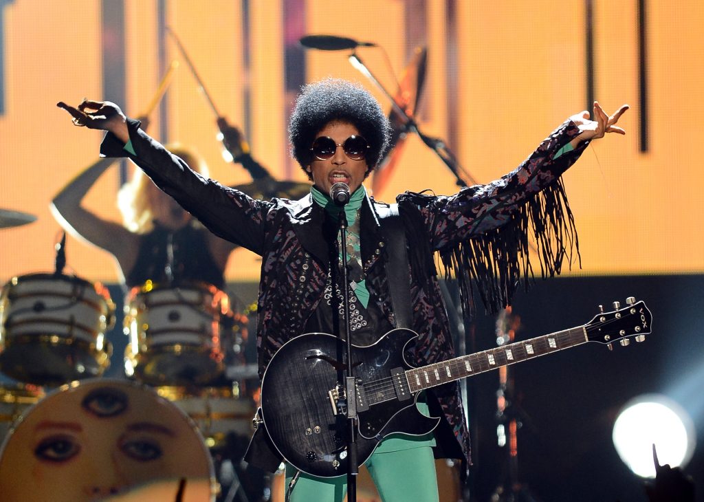 (FILES) This file photo taken on May 18, 2013 shows musician Prince performing onstage during the 2013 Billboard Music Awards at the MGM Grand Garden Arena on May 19, 2013 in Las Vegas, Nevada. Pop icon Prince died at his compound in Minnesota on April 21, 2016, a representative said. He was 57. "It is with profound sadness that I am confirming that the legendary, iconic performer, Prince Rogers Nelson, has died at his Paisley Park residence this morning," said his spokeswoman, Yvette Noel-Schure. / AFP PHOTO / GETTY IMAGES NORTH AMERICA / Ethan Miller