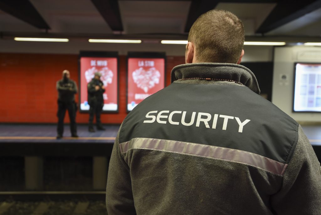 Security agents stand at the Maelbeek - Maalbeek metro station on its re-opening day on April 25, 2016 in Brussels, after being closed since the 22 March attacks in the Belgian capital.  Maelbeek - Maalbeek metro station was hit by one of the three Islamic State suicide bombers who struck Brussels airport and metro on March 22, killing 32 people and injuring hundreds. / AFP PHOTO / JOHN THYS