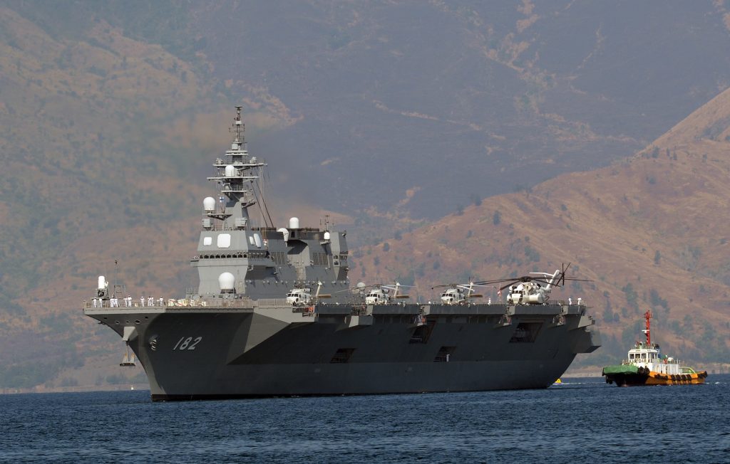 Japanese helicopter carrier Ise is towed as it prepares to dock at the former US naval base, Subic port, north of Manila on April 26, 2016. Ise (DDH 182), which is in the Philippines for a four-day goodwill visit, marking a third time Japanese vessels have visited the country in a year, with two Japanese destroyers and a submarine docked April 3 near disputed South China Sea waters, where Beijing's increasingly assertive behaviour has sparked global concern. / AFP PHOTO / TED ALJIBE