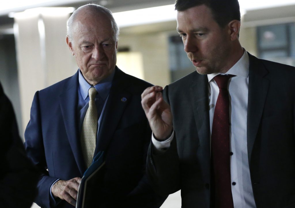 United Nations Syria envoy Staffan de Mistura (L) arrives for a meeting with the Syrian government delegation during Syria Peace talks at the United Nations in Geneva, on April 26, 2016.  Syria's fragile ceasefire is in grave peril, US President Barack Obama and the UN's special envoy warned on April 22, 2016, as violence surged in the war-ravaged country's second city Aleppo. The truce "is still in effect, but it is in great trouble if we don't act quickly", the United Nations' top envoy for Syria, Staffan de Mistura, told reporters in Geneva, where he is mediating faltering peace talks. / AFP PHOTO / POOL / DENIS BALIBOUSE