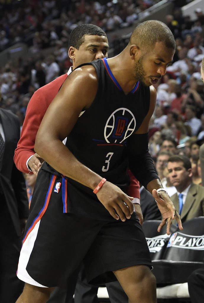 PORTLAND, OR - APRIL 25: Chris Paul #3 of the Los Angeles Clippers walks off the court after he injured his hand in the third quarter of Game Four of the Western Conference Quarterfinals against the Portland Trail Blazers during the 2016 NBA Playoffs at the Moda Center on April 25, 2016 in Portland, Oregon. The Blazers won the game 98-84. NOTE TO USER: User expressly acknowledges and agrees that by downloading and/or using this photograph, user is consenting to the terms and conditions of the Getty Images License Agreement. Steve Dykes/Getty Images/AFP