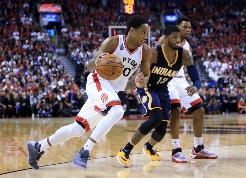 TORONTO, ON - APRIL 26: DeMar DeRozan #10 of the Toronto Raptors dribbles the ball as Paul George #13 the Indiana Pacers defends in the second half of Game Five of the Eastern Conference Quarterfinals during the 2016 NBA Playoffs at the Air Canada Centre on April 26, 2016 in Toronto, Ontario, Canada. NOTE TO USER: User expressly acknowledges and agrees that, by downloading and or using this photograph, User is consenting to the terms and conditions of the Getty Images License Agreement. Vaughn Ridley/Getty Images/AFP