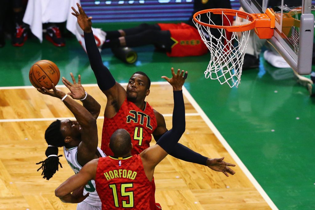 BOSTON, MA - APRIL 28: Paul Millsap #4 of the Atlanta Hawks and Al Horford #15 of the Atlanta Hawks defend a shot by Jae Crowder #99 of the Boston Celtics during the first quarter of Game Six of the Eastern Conference Quarterfinals during the 2016 NBA Playoffs at TD Garden on April 28, 2016 in Boston, Massachusetts. NOTE TO USER User expressly acknowledges and agrees that, by downloading and or using this photograph, user is consenting to the terms and conditions of the Getty Images License Agreement. Maddie Meyer/Getty Images/AFP
