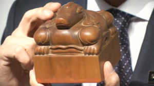 A seal described by Sotheby's as "the most important Chinese historical object ever offered at an auction" goes under the hammer for $11.8 million.(photo grabbed from Reuters video) 