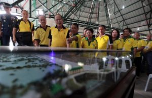 President Benigno S. Aquino III presses the power button switching on the scale model during the launching of the AngatAfterbay Regulatory Dam (Bustos Dam) Rehabilitation Project in Barangay Tibagan, Bustos, Bulacan on Friday (April 15). (Photo by BenhurArcayan/ Malacañang Photo Bureau)