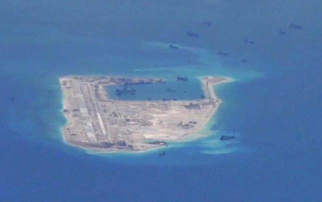 Chinese dredging vessels are purportedly seen in the waters around Fiery Cross Reef in the disputed Spratly Islands in the South China Sea in this still image from video taken by a P-8A Poseidon surveillance aircraft provided by the United States Navy May 21, 2015. REUTERS/U.S. Navy/Handout via Reuters