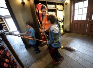 Dove Rudman (C) and her children, Wyatt (L) and Cody try out witch brooms for sale inside Dervish and Banges general store in Hogsmeade Village during a soft opening and media tour of "The Wizarding World of Harry Potter" theme park at the Universal Studios Hollywood in Los Angeles, California in this picture taken March 22, 2016. REUTERS/Kevork Djansezian