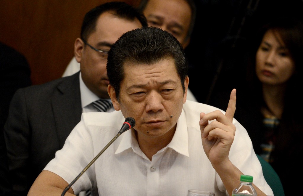 Casino junket operator Kim Wong gestures as he gives a statement during a senate hearing in Manila on April 19, 2016. Unidentified hackers on February 5 shifted 81 million USD from the Bangladesh central bank's account with the US Federal Reserve to a nondescript bank in Manila, and then to the casinos where the trail went cold. Representatives for casino agent Kim Wong, who is under criminal investigation after a portion of the stolen money was traced to his account, surrendered 4.63 million USD in cash to the Philippine central bank. / AFP PHOTO / NOEL CELIS