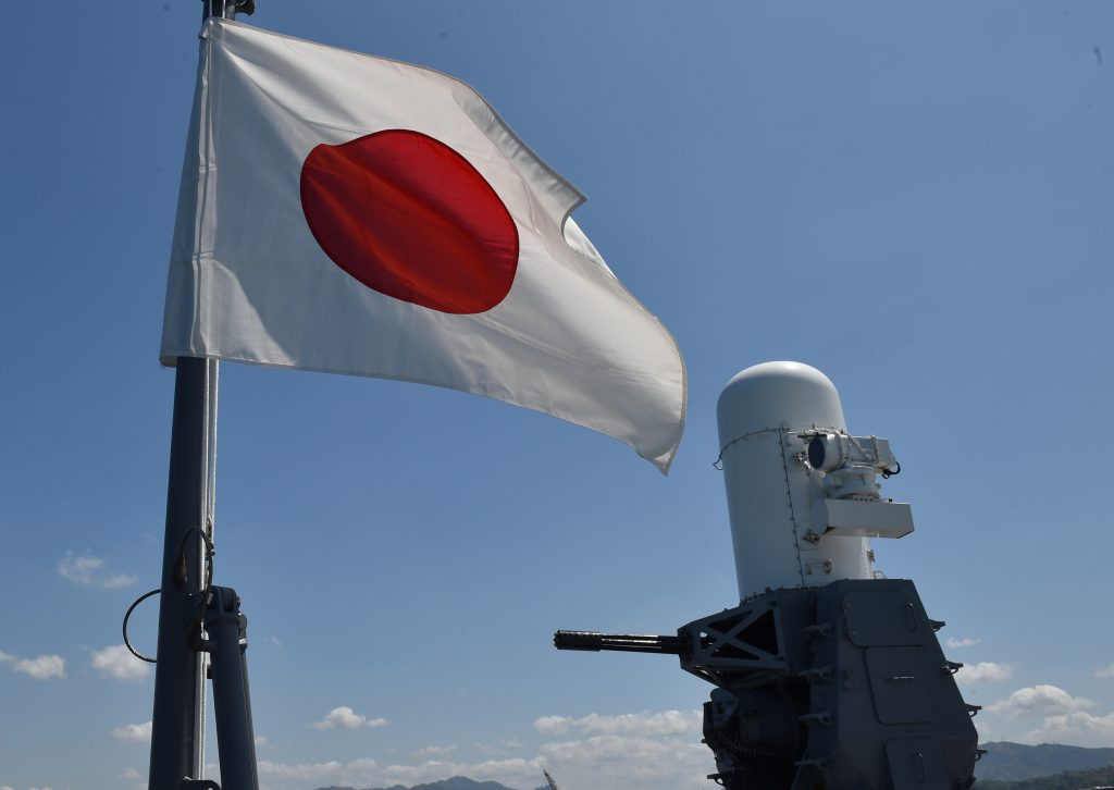 A Japanese flag flutters next to one of the two Close-in Weapon System (CIWSs) aboard helicopter carrier Ise shortly after docking at the former US naval base, Subic port, north of Manila on April 26, 2016. Ise (DDH 182), which is in the Philippines for a four-day goodwill visit, marking a third time Japanese vessels have visited the country in a year, with two Japanese destroyers and a submarine docked April 3 near disputed South China Sea waters, where Beijing's increasingly assertive behaviour has sparked global concern. / AFP PHOTO / TED ALJIBE