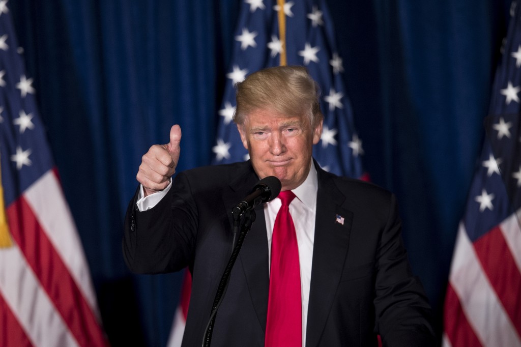 Republican presidential candidate Donald Trump gives a thumbs up after delivering a foreign policy speech at the Mayflower Hotel April 27, 2016 in Washington, DC. Donald Trump pledged Wednesday to pursue an "American First" foreign policy if elected president, demanding that allies contribute more to global security. "America First will be the major and overriding theme of my administration," he said in a speech outlining his foreign policy. / AFP PHOTO / Brendan Smialowski